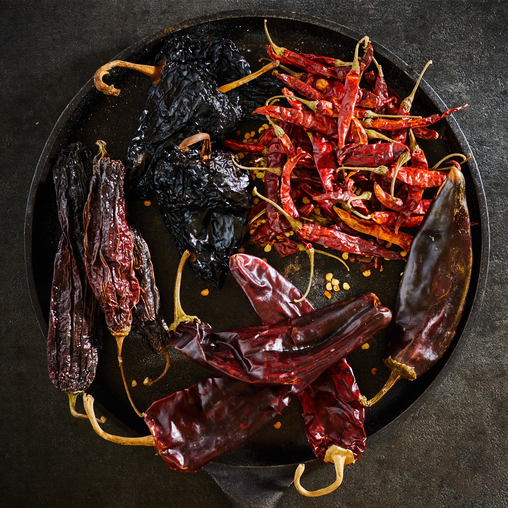 Chili Pod Collection Variety of dried chili pods on wooden table
