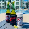 Fiesta Brand Beer Salt with lime wedge and two beers by the pool