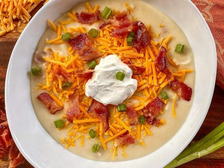 finished bowl of JALAPEÑO LOADED BAKED POTATO SOUP with crumbles of crispy bacon and shredded cheese on top